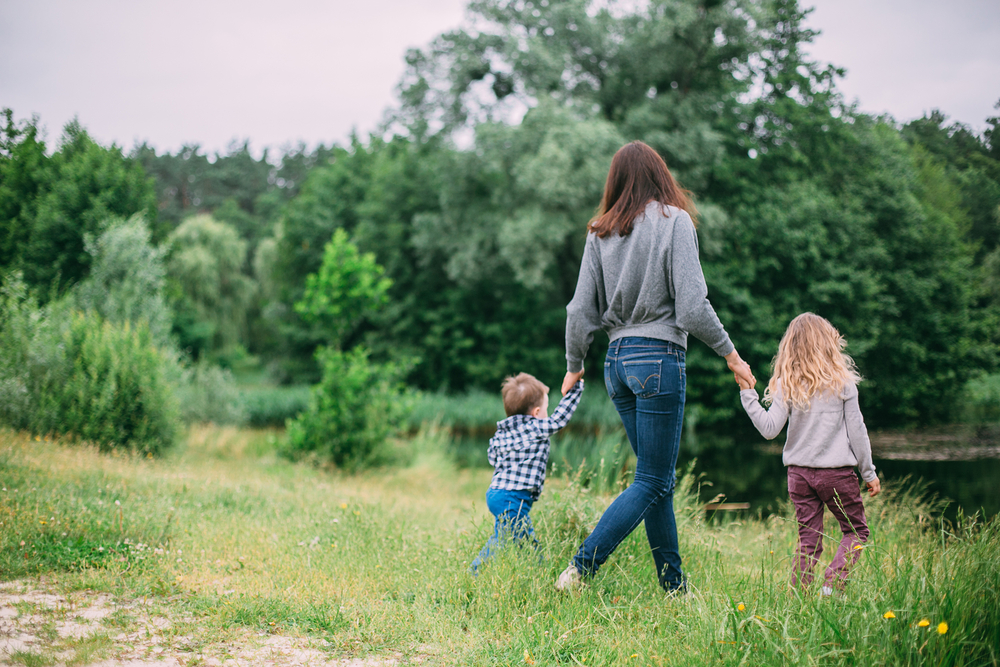 a woman walking with her small children