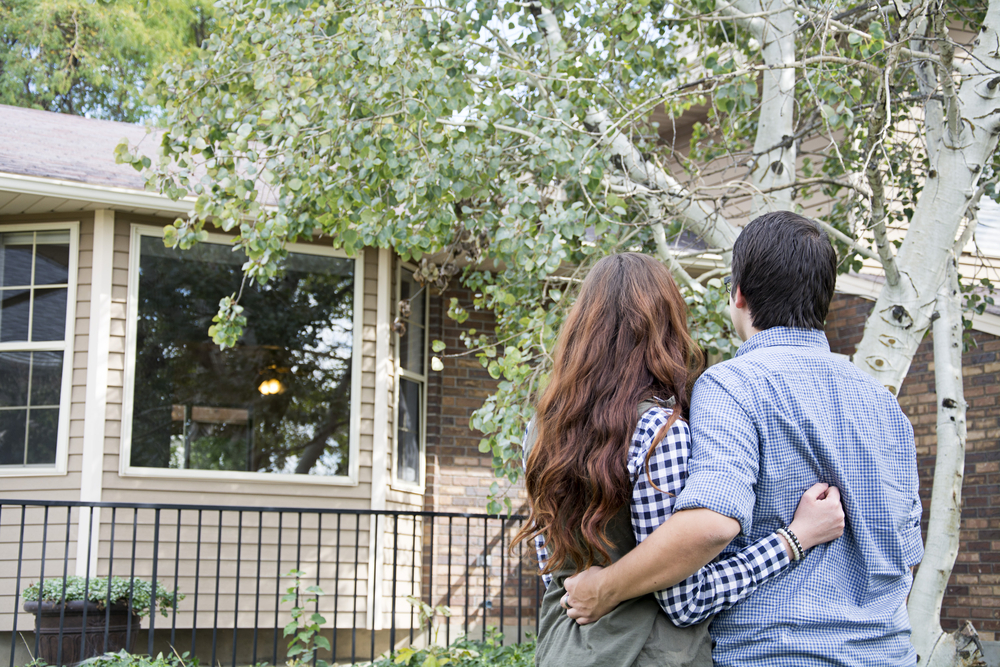 a happy couple looking at their new home purchased with a mortgage loan from Telco credit union