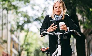 Woman on phone on a bike